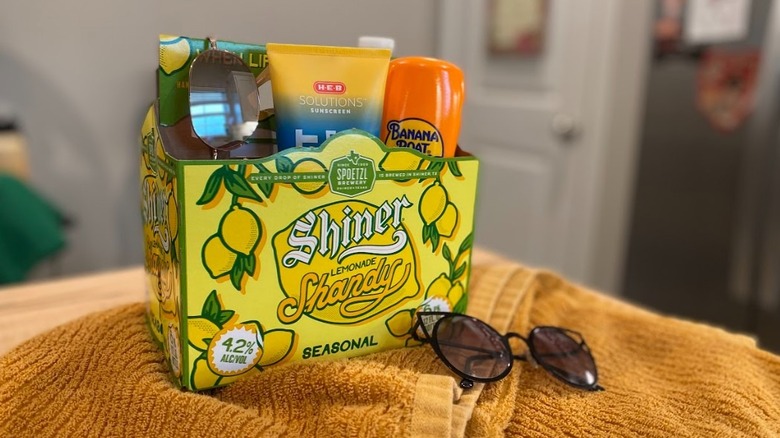 Sunscreen and sunglasses in beer box