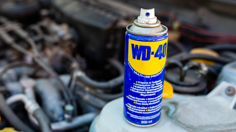 Can of WD-40 next to a car engine