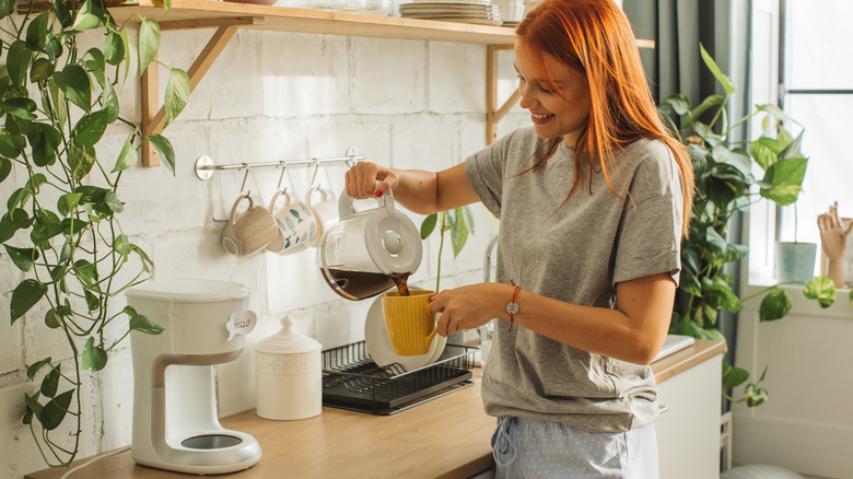 woman pouring from coffee maker