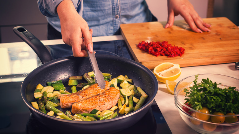 person cooking fish