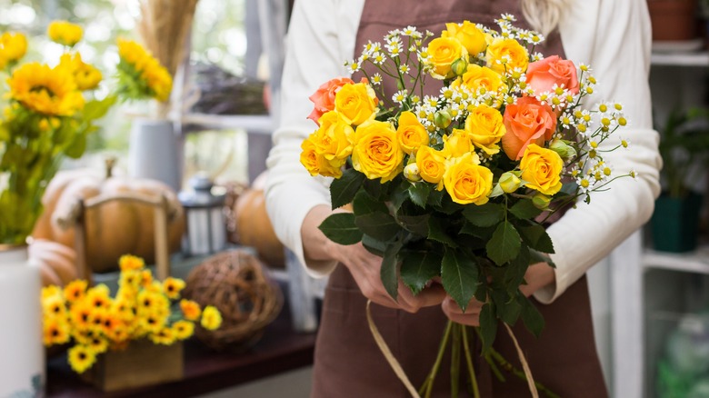 Florist arranging fall flowers