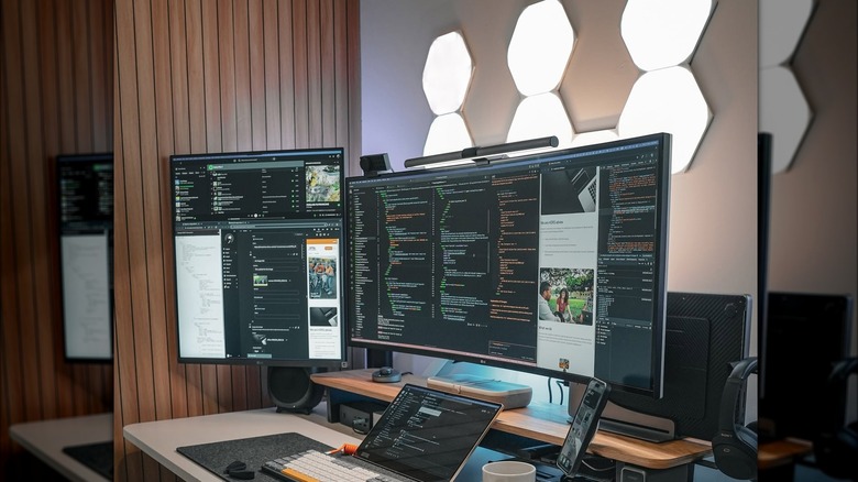 Hexagonal light panels on wall behind home office desk