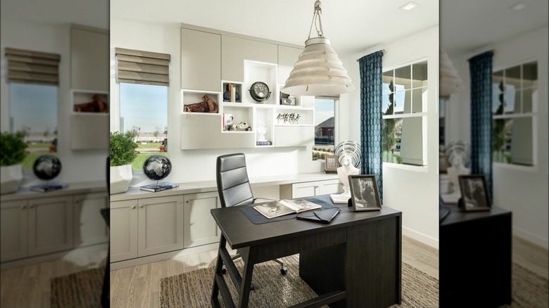 A white coil-like chandelier hanging over office desk