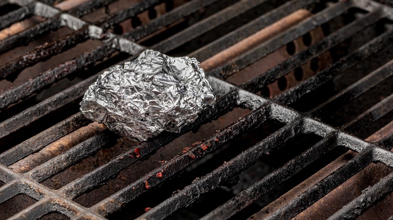 Ball of aluminum foil on grill grate