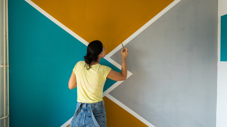 woman painting colorful wall