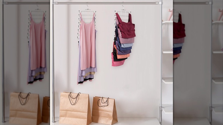 Colorful tank tops and bras hang on a specialty hanger