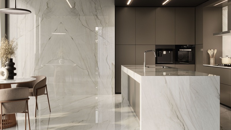 A kitchen with mable-like ceramic slab counters and walls