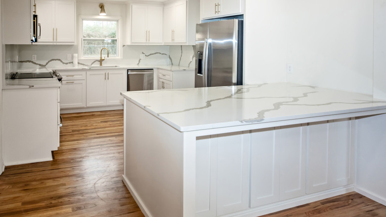 A kitchen with white quartz countertops