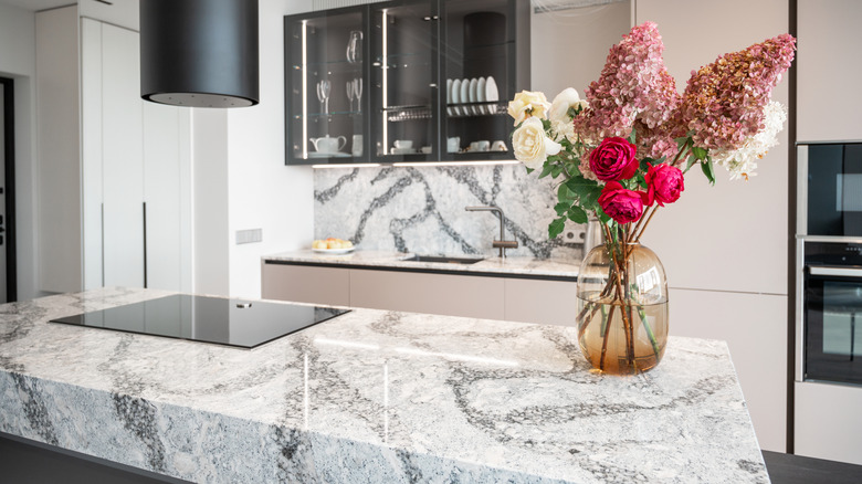 A kitchen with white granite countertops