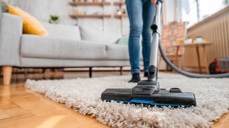 Close-up of vacuuming a rug