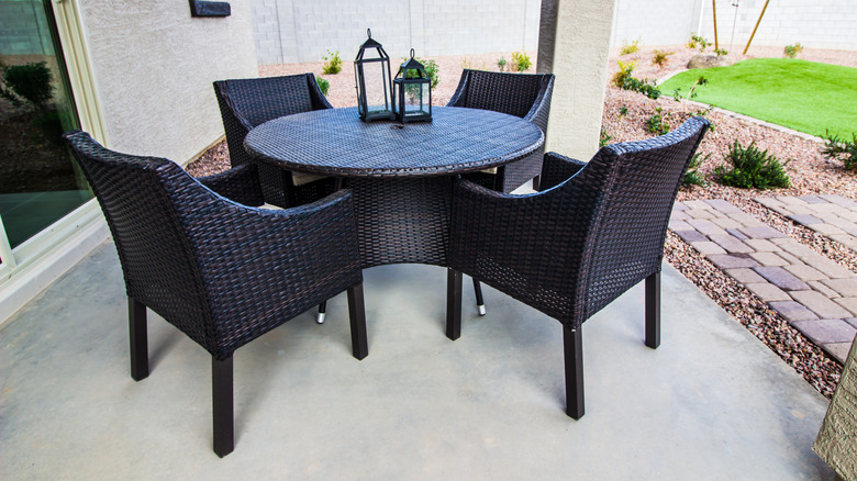 A patio with a dining table and chairs