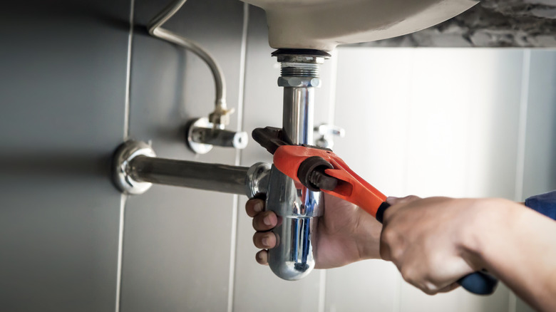 Fixing the pipes under a sink