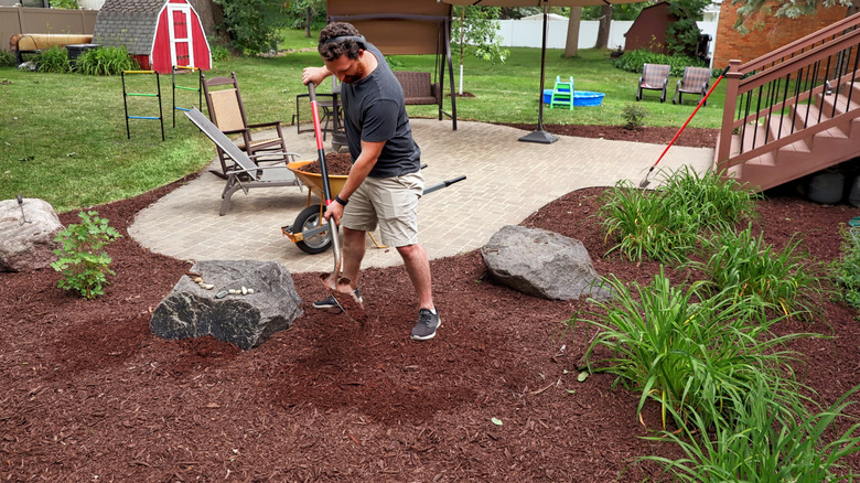 A man mulching a garden