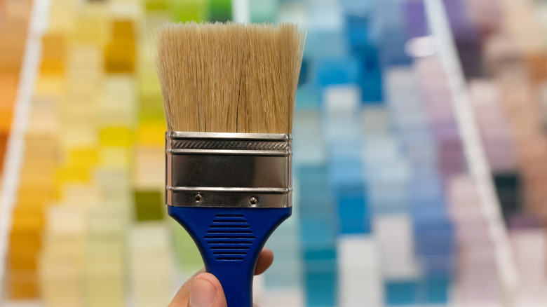 A paint brush in front of paint samples