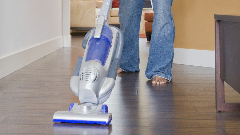 man vacuuming floor