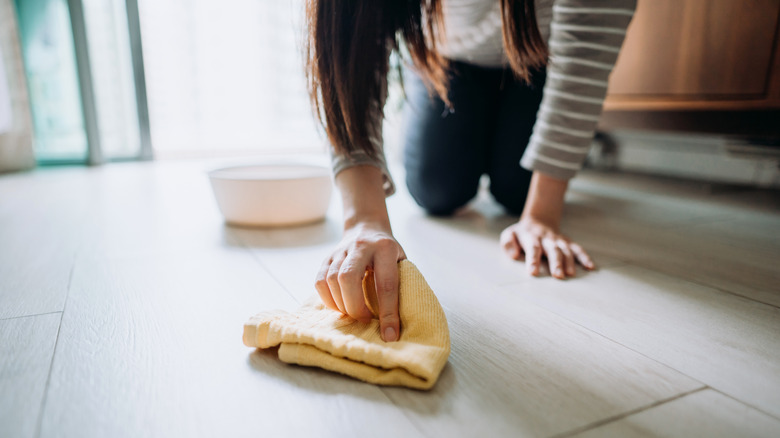 person wiping floor