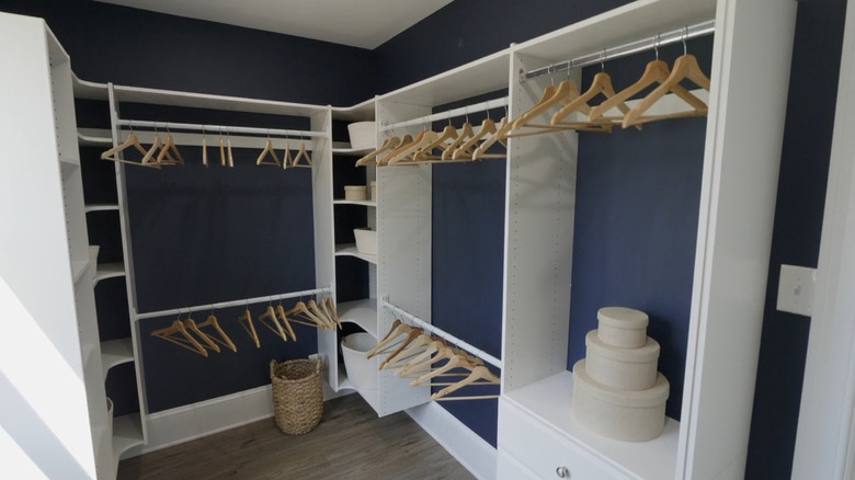 An empty closet with navy blue walls.