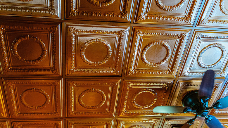 Tin ceiling panels surrounding a ceiling fan