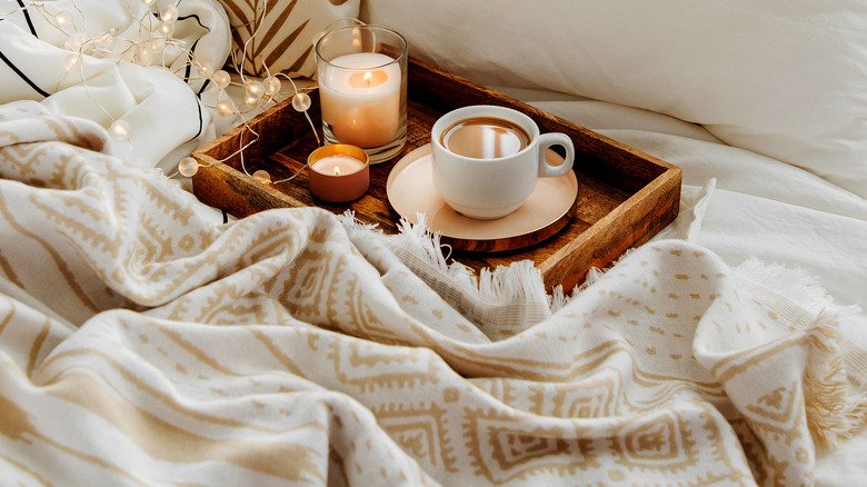 Comfy blanket with candles and cocoa