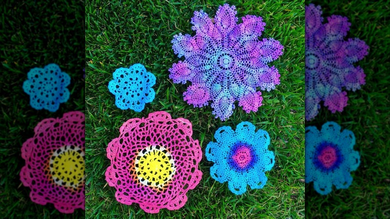 Vibrant dyed doilies sitting on bright green grass