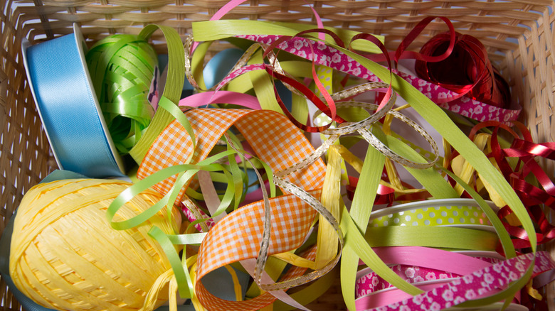 Looking into a basket filled with disorganized, colorful ribbon.