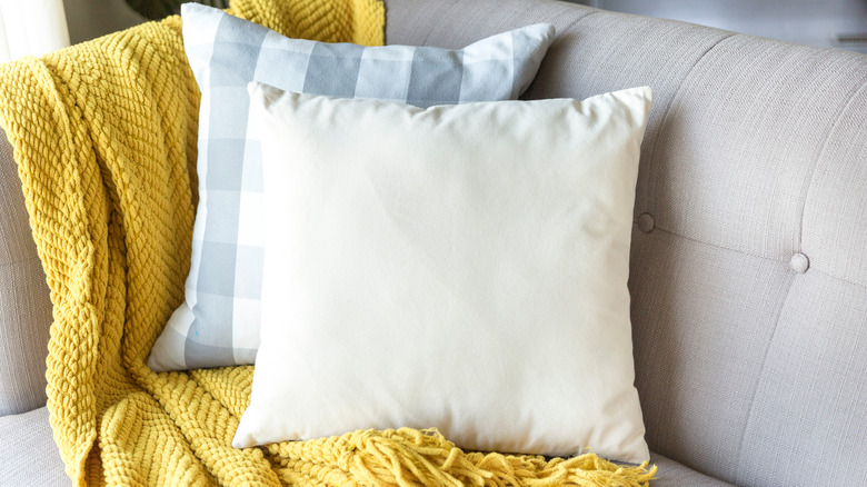 yellow throw blanket and pillows