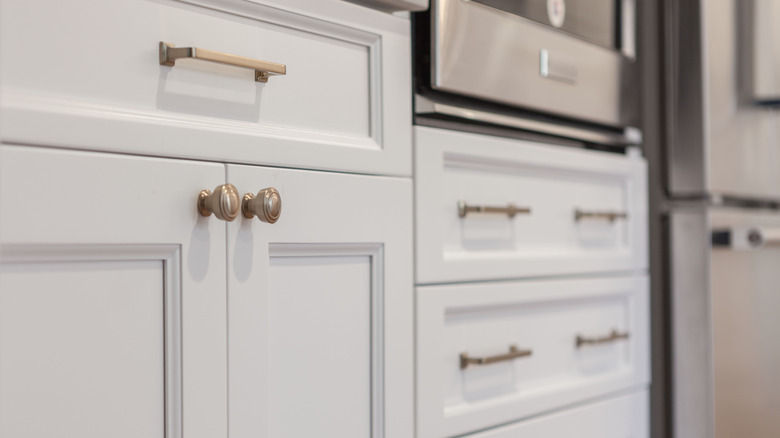 white kitchen with metal knobs