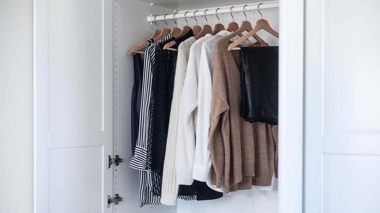 white closet with wooden hangers