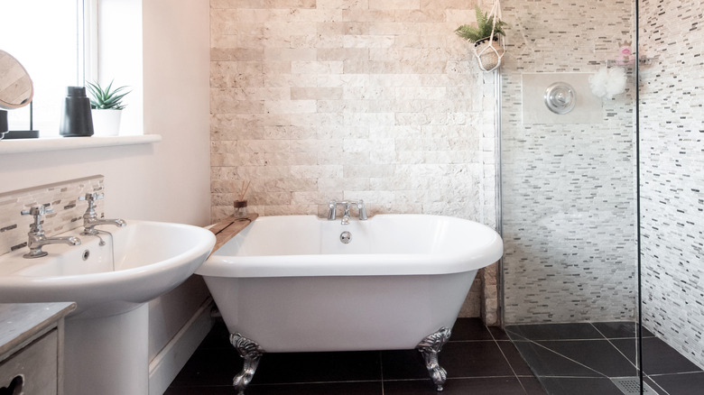 Bathtub in front of natural stone wall