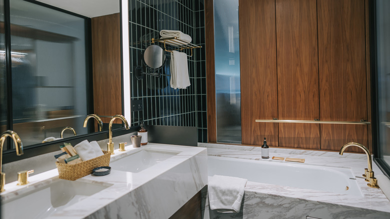 A bathroom designed with wood paneling in the shower