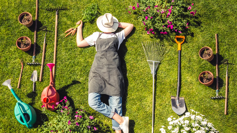 gardener surrounded by gardening tools