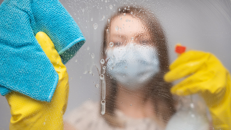 person cleaning in mask and gloves