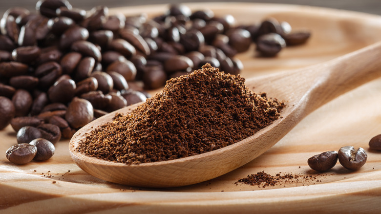 Dry coffee grounds and coffee beans