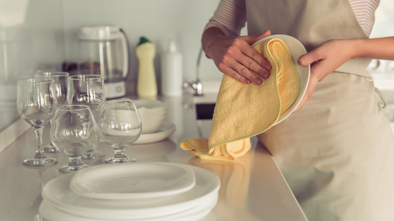 Drying dishes with a towel