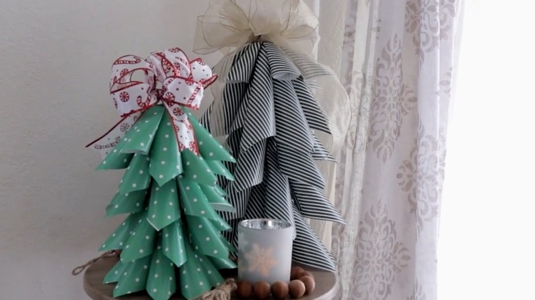 Two decorative trees made out of wrapping paper and wrapping paper tubes