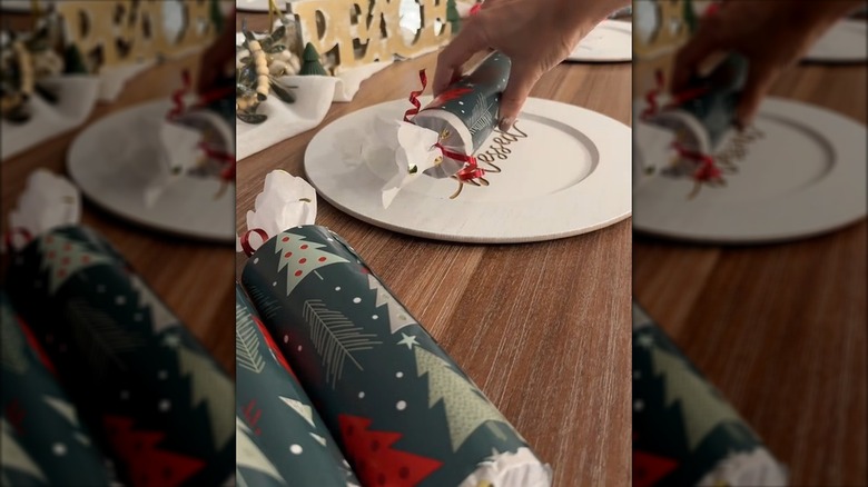 Christmas crackers made of wrapping paper tubes, wrapping paper, and tissue paper