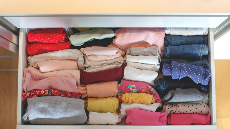 folded clothes in dresser drawer