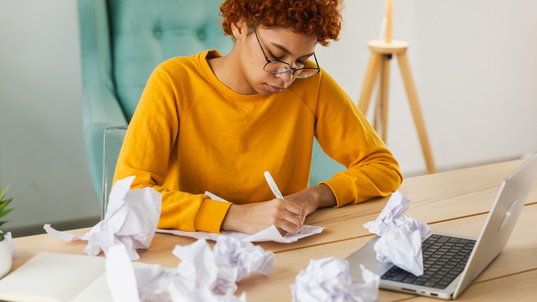 woman writing on paper