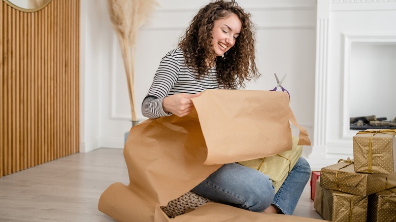 woman wrapping gifts with paper