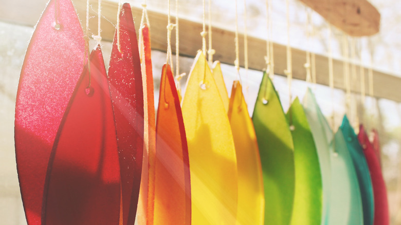 rainbow colored glass suncatcher hanging in sunlight