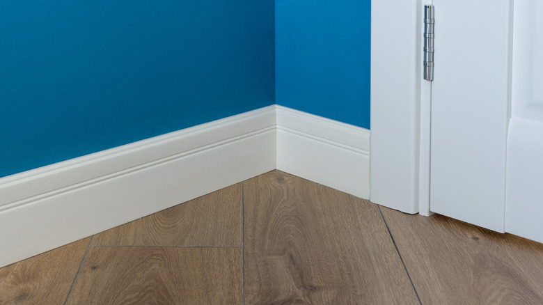 White baseboard in blue room