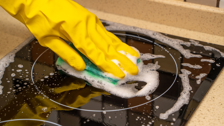 person with yellow glove cleaning