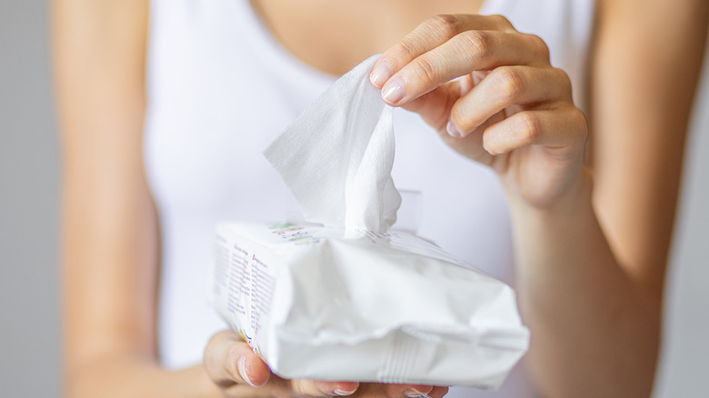 women holding cleaning wipes