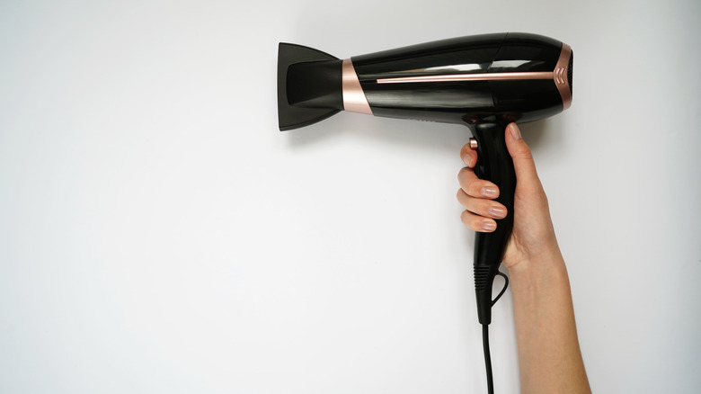 Person holding a blow dryer