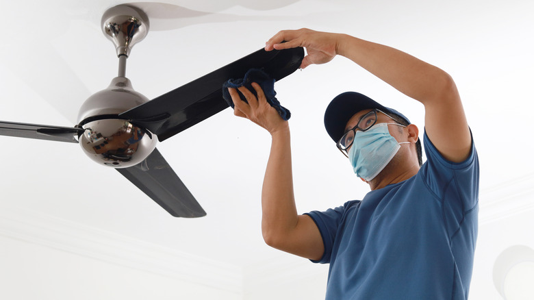 Wiping down a ceiling fan blade