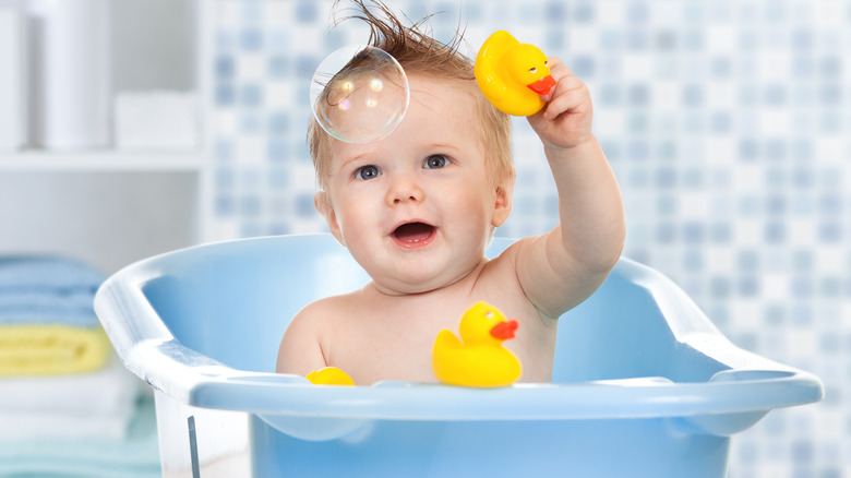 Baby playing with bath toys