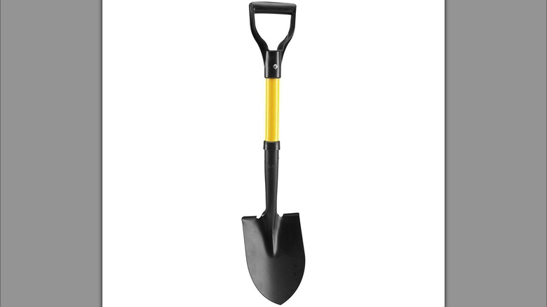 A yellow round nose mini shovel is shown in detail