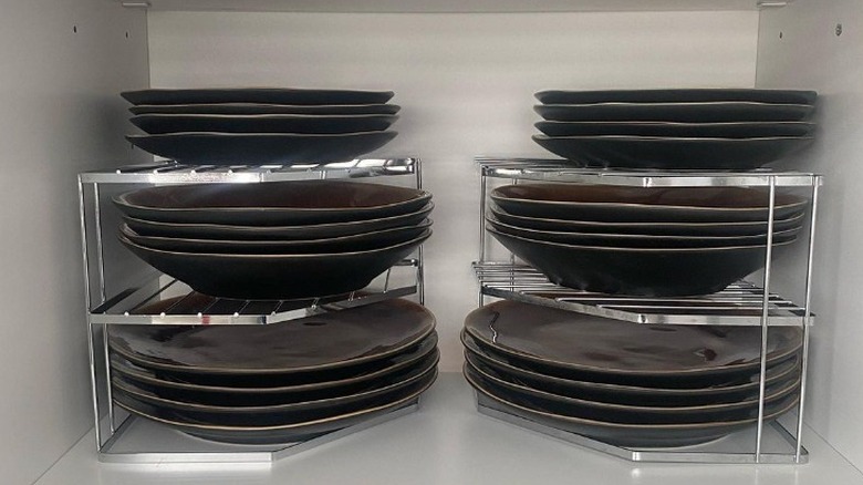 Plates stacked on shelf raisers