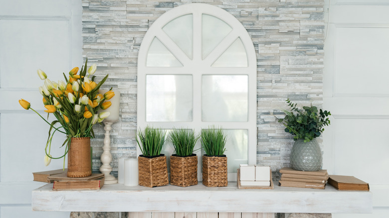 A mantel with tulips and woven baskets