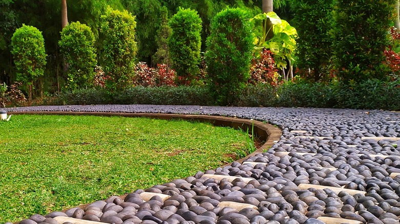 Dark cobblestones along the edge of a lawn